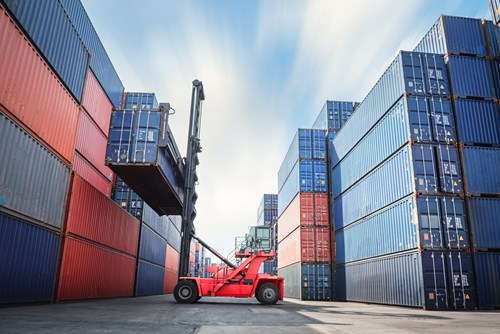 Straddle carrier lifting a container